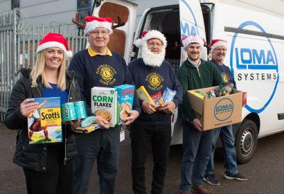 Farnborough Lions and Loma Systems Staff load food donations for the Community Store